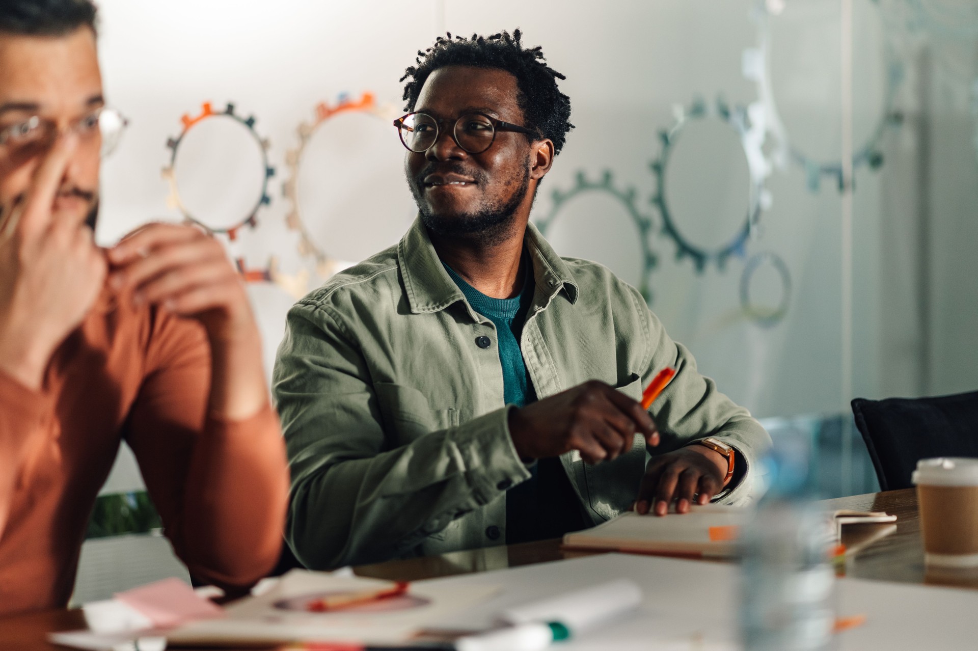 Marketing professional sharing ideas during creative meeting in modern office